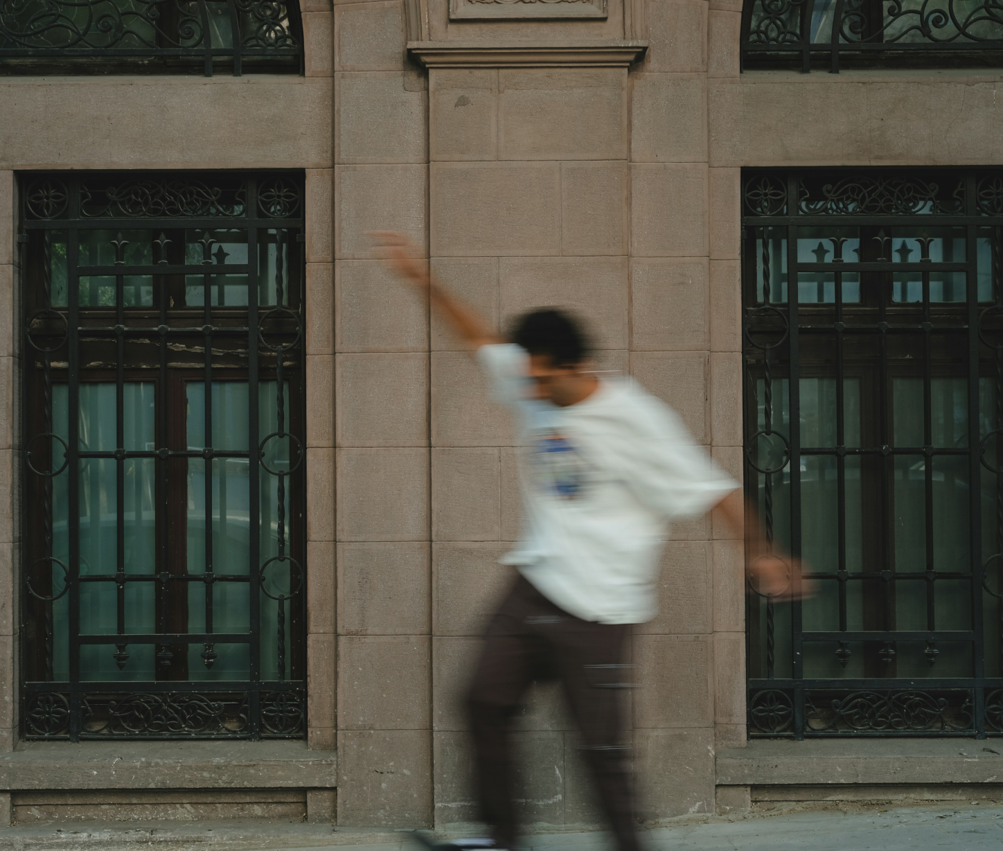 Skateboarder in front of elegant building